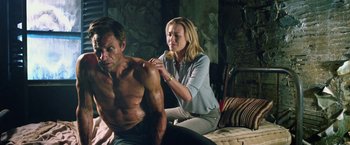 Movie still from “I, Frankenstein” (2014), directed by Stuart Beattie – A man and a woman sitting next to each other on a bed; Medium shot, Low angle