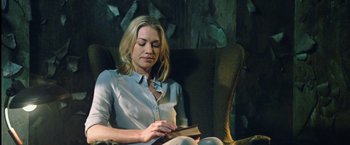 Movie still from “I, Frankenstein” (2014), directed by Stuart Beattie – A woman sitting in a chair reading a book; Medium shot, Over the shoulder angle