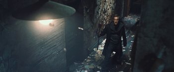 Movie still from “I, Frankenstein” (2014), directed by Stuart Beattie – A man holding a knife in a room with broken walls; Wide shot, High angle