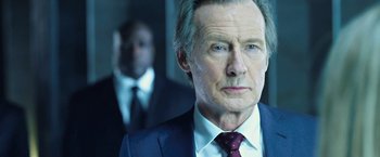 Movie still from “I, Frankenstein” (2014), directed by Stuart Beattie – An older man wearing a suit and tie; Close Up shot, Over the shoulder angle