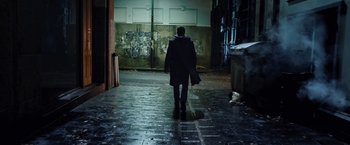 Movie still from “I, Frankenstein” (2014), directed by Stuart Beattie – A man walking down a street in a dark place; Wide shot, Low angle