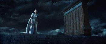 Movie still from “I, Frankenstein” (2014), directed by Stuart Beattie – A woman standing on the side of a brick wall; Wide shot, Low angle