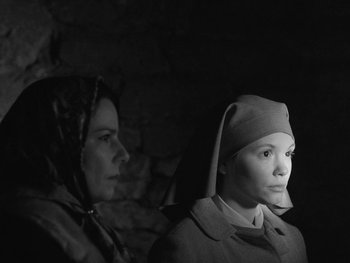 Movie still from “Ida” (2013), directed by Pawel Pawlikowski – Two women are sitting next to each other in a dark room; Close Up shot, Low angle