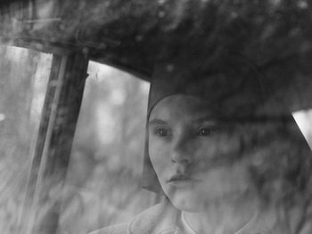 Movie still from “Ida” (2013), directed by Pawel Pawlikowski – A young girl is looking out of a window; Close Up shot, High angle
