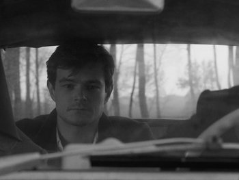 Movie still from “Ida” (2013), directed by Pawel Pawlikowski – A black and white photo of a man sitting in the back of a car; Close Up shot, Over the shoulder angle