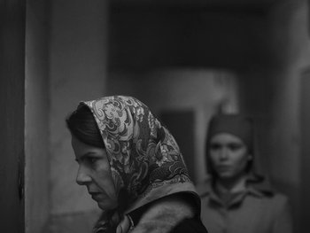 Movie still from “Ida” (2013), directed by Pawel Pawlikowski – A woman wearing a head scarf standing next to another woman; Close Up shot, Low angle