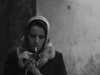 Movie still from “Ida” (2013), directed by Pawel Pawlikowski – A woman smoking a cigarette while wearing a scarf; Close Up shot, Low angle