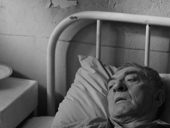 Movie still from “Ida” (2013), directed by Pawel Pawlikowski – An older man laying in a hospital bed; Close Up shot, High angle