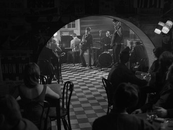 Movie still from “Ida” (2013), directed by Pawel Pawlikowski – A black and white photo of people in a restaurant; Wide shot, High angle