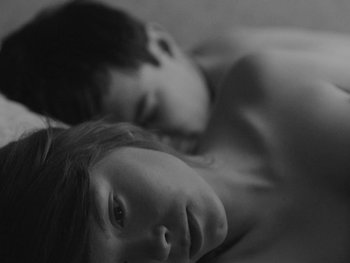 Movie still from “Ida” (2013), directed by Pawel Pawlikowski – A young boy and a young girl laying on a bed; Close Up shot, Overhead angle