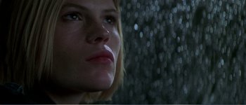 Movie still from “Identity” (2003), directed by James Mangold – A woman's face in front of a waterfall; Close Up shot, Low angle