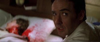 Movie still from “Identity” (2003), directed by James Mangold – A person with blood on his face; Close Up shot, Over the shoulder angle
