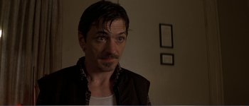 Movie still from “Identity” (2003), directed by James Mangold – A person wearing a jacket and looking at the camera; Close Up shot, Low angle