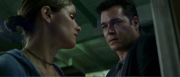 Movie still from “Identity” (2003), directed by James Mangold – A man and a woman staring at each other; Close Up shot, Low angle