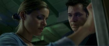 Movie still from “Identity” (2003), directed by James Mangold – A man and a woman looking at each other; Close Up shot, Low angle