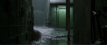 Movie still from “Identity” (2003), directed by James Mangold – A green door in the middle of a rain storm; Extreme Wide shot, High angle
