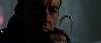 Movie still from “Identity” (2003), directed by James Mangold – A person holding something in his hand; Close Up shot, Low angle