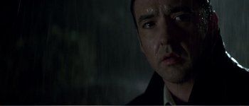 Movie still from “Identity” (2003), directed by James Mangold – A person in a rainstorm; Close Up shot, Low angle