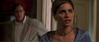 Movie still from “Identity” (2003), directed by James Mangold – A woman that is standing in front of a window; Close Up shot, Over the shoulder angle