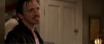 Movie still from “Identity” (2003), directed by James Mangold – A person standing in front of a door; Close Up shot, Over the shoulder angle