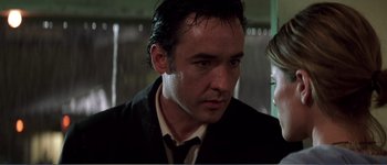 Movie still from “Identity” (2003), directed by James Mangold – A person wearing a suit and tie; Close Up shot, Low angle