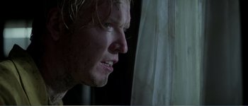 Movie still from “Identity” (2003), directed by James Mangold – A person looking out of a window; Close Up shot, Over the shoulder angle