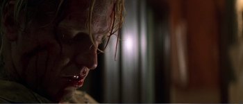 Movie still from “Identity” (2003), directed by James Mangold – A person with blood dripping from their mouth; Close Up shot, Low angle