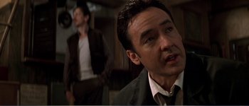Movie still from “Identity” (2003), directed by James Mangold – A man in a black jacket and a man in a white shirt; Close Up shot, Over the shoulder angle