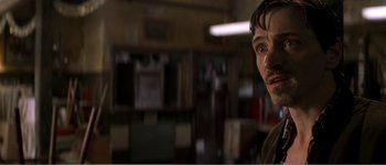 Movie still from “Identity” (2003), directed by James Mangold – A person in a room looking at the camera; Close Up shot, Low angle