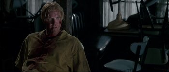 Movie still from “Identity” (2003), directed by James Mangold – A man in a yellow jacket with blood on his face; Close Up shot, Over the shoulder angle