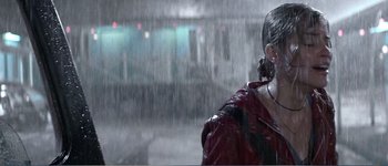 Movie still from “Identity” (2003), directed by James Mangold – A woman in a red raincoat standing in the pouring rain; Close Up shot, Low angle