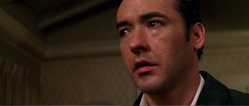 Movie still from “Identity” (2003), directed by James Mangold – A man's face with tears coming out of his eyes; Close Up shot, Low angle