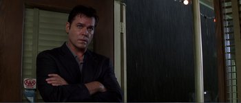 Movie still from “Identity” (2003), directed by James Mangold – A person standing in front of a window; Close Up shot, Low angle