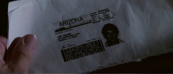 Movie still from “Identity” (2003), directed by James Mangold – An arizona driver's license is shown on a piece of paper; Extreme Close Up shot, High angle