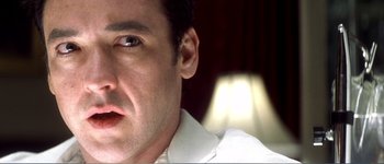 Movie still from “Identity” (2003), directed by James Mangold – A man's face in front of a lamp; Extreme Close Up shot, Low angle