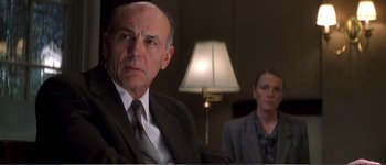 Movie still from “Identity” (2003), directed by James Mangold – A man and a woman sitting in front of a lamp; Close Up shot, Over the shoulder angle