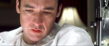 Movie still from “Identity” (2003), directed by James Mangold – A man's face in a white shirt; Extreme Close Up shot, Low angle