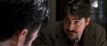 Movie still from “Identity” (2003), directed by James Mangold – A person looking at his reflection in a mirror; Close Up shot, Over the shoulder angle