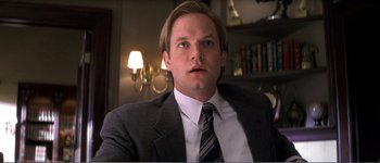 Movie still from “Identity” (2003), directed by James Mangold – A person wearing a suit and tie; Close Up shot, Low angle