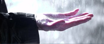 Movie still from “Identity” (2003), directed by James Mangold – A person's hand is shown in the rain; Extreme Close Up shot, Low angle