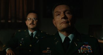 Movie still from “Idiocracy” (2006), directed by Mike Judge – Two men in military uniforms are looking at the camera; Medium shot, Low angle