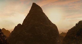 Movie still from “Idiocracy” (2006), directed by Mike Judge – The sun is setting behind a large rock formation; Extreme Wide shot, Low angle