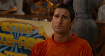 Movie still from “Idiocracy” (2006), directed by Mike Judge – A person wearing an orange t - shirt; Close Up shot, Over the shoulder angle