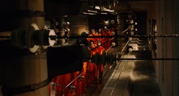 Movie still from “Idiocracy” (2006), directed by Mike Judge – A group of people dressed in orange are standing in front of a mirror; Extreme Wide shot, High angle