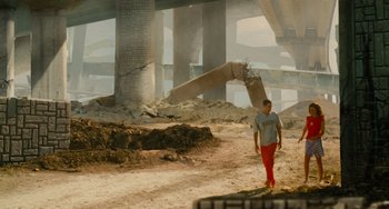 Movie still from “Idiocracy” (2006), directed by Mike Judge – A man standing in the middle of a dirt field; Wide shot, Low angle