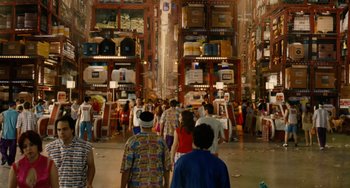Movie still from “Idiocracy” (2006), directed by Mike Judge – A group of people walking down a street; Extreme Wide shot, High angle