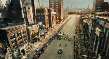 Movie still from “Idiocracy” (2006), directed by Mike Judge – An aerial view of a street with a crowd of people on it; Extreme Wide shot, High angle