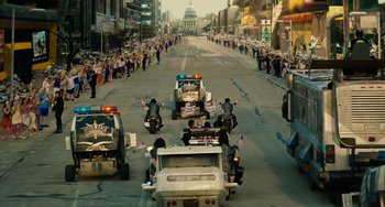 Movie still from “Idiocracy” (2006), directed by Mike Judge – A group of people riding motorcycles down a street; Extreme Wide shot, High angle