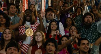 Movie still from “Idiocracy” (2006), directed by Mike Judge – A group of people are posing for a picture; Medium shot, High angle