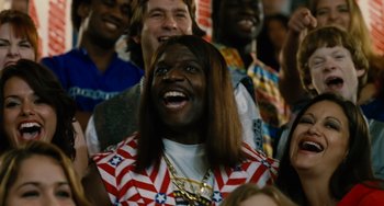 Movie still from “Idiocracy” (2006), directed by Mike Judge – A group of people that are sitting in a crowd; Close Up shot, Over the shoulder angle